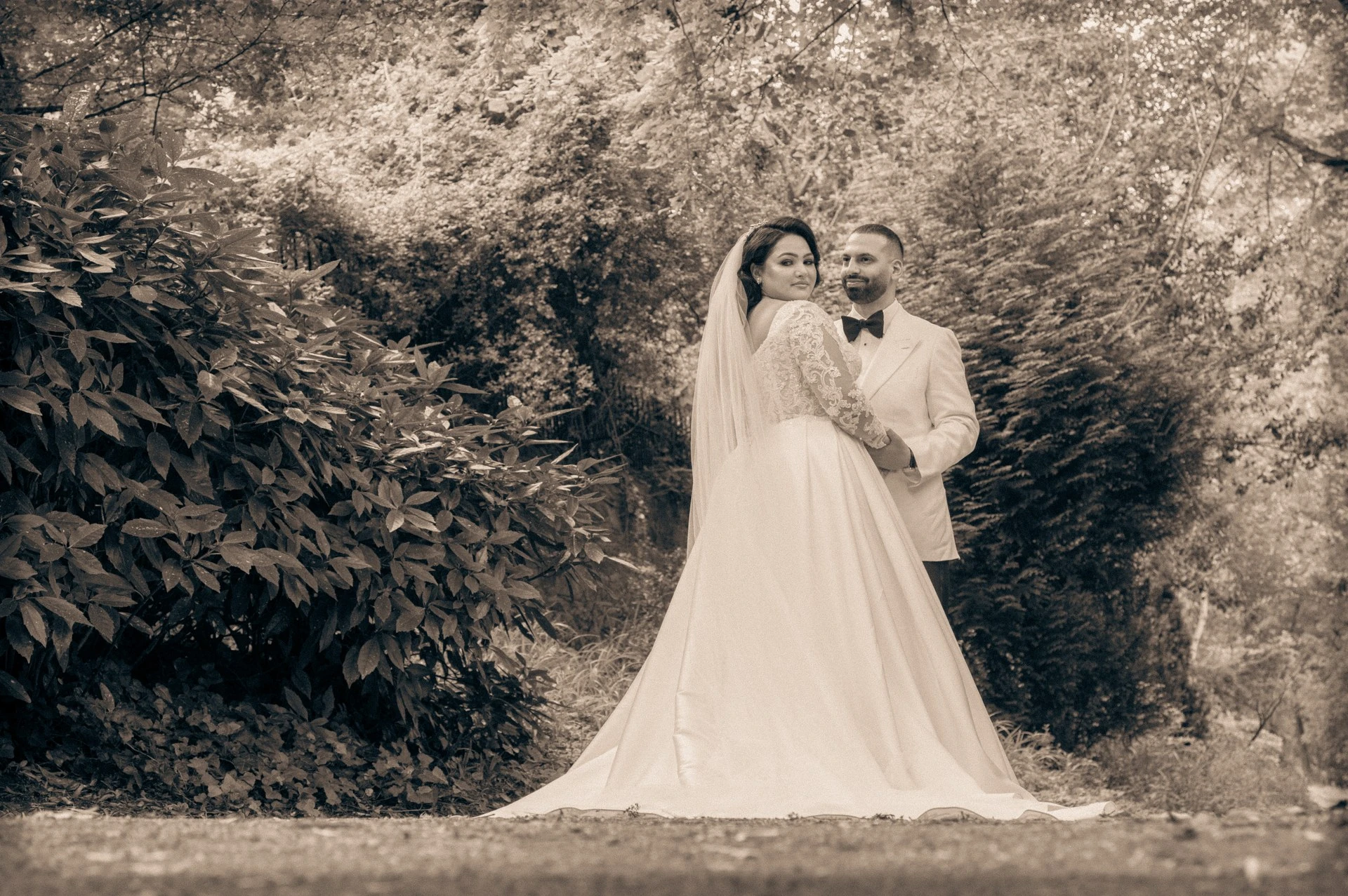 Bride and groom sepia portrait in garden setting, wedding photography by Eyecon Moments